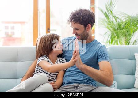 Father playing with his children at home Stock Photo