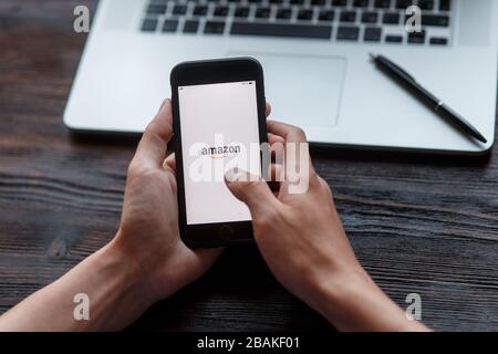 online shopping through the phone. hands with phone close up shopping through amazon Stock Photo
