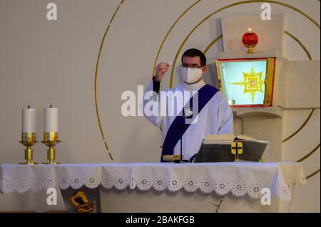 Bratislava, Slovakia. 2019/3/20. A deacon holding the Host before distributing the Eucharist to the faithful in a church during the COVID-19 pandemic. Stock Photo