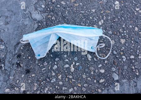 Brooklyn, NY - 27 March 2020. Restrictions on the public during the COVID-19 pandemic have led shortages of surgical masks and gloves. Despite the scarcity, both are often discarded, and can be found on the city's streets and sidewalks. Stock Photo