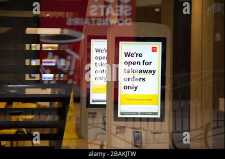 Glasgow, UK. 27 March 2020.   Pictured: Sign which is displayed on self ordering screen in a closed McDonald’s Restaurant advising customers ‘We’re open for takeaway orders only.”  Shop notice advising customers they are closed due to the coronavirus pandemic which has forced Glasgow into a lockdown situation.   The Coronavirus Pandemic has forced the UK Government to order a shut down of all the UK major cities and make people stay at home. Stock Photo