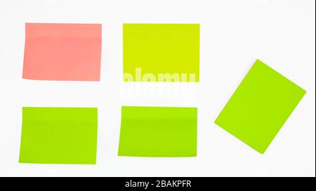 Five different colored paper sticky notes displayed before an isolated white background Stock Photo