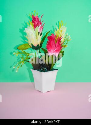 Portrait of a miniature flower bouquet with different colored small flowers on top of a desk Stock Photo