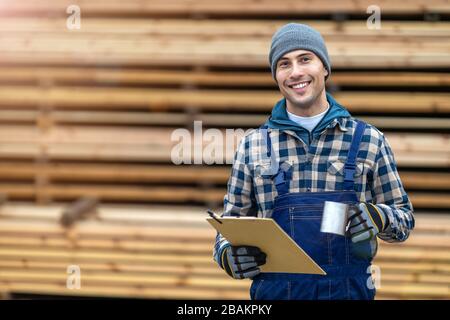 Young male worker in timber warehouse Stock Photo