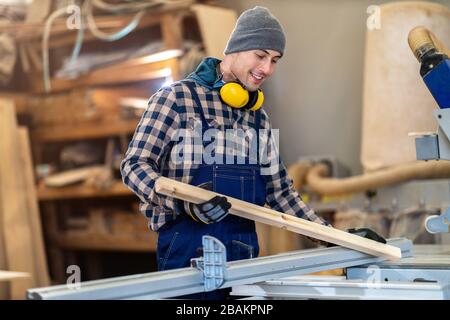 Young male worker in timber warehouse Stock Photo