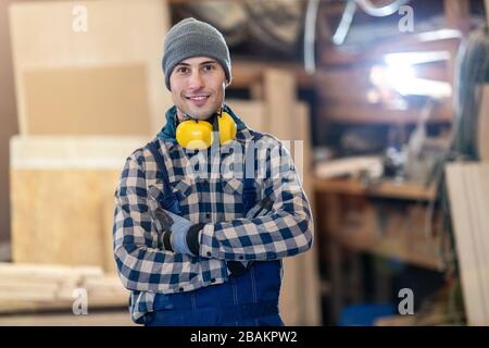 Young male worker in timber warehouse Stock Photo
