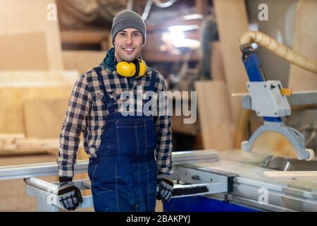 Young male worker in timber warehouse Stock Photo