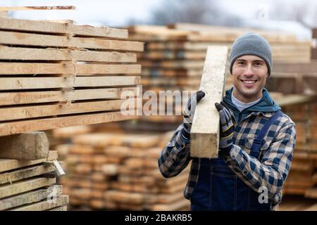 Young male worker in timber warehouse Stock Photo