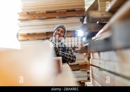 Young male worker in timber warehouse Stock Photo