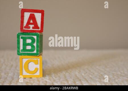 Letter Blocks stacked vertical that spell ABC on soft background Stock Photo