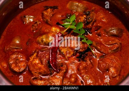 Kerala style spicy fish coconut curry in a metal pot, close up view Stock Photo