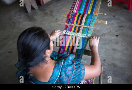 Lake Atitaln, Guatemala, 26th february 2020: mayan woman weaving colorful, traditional fabrics Stock Photo