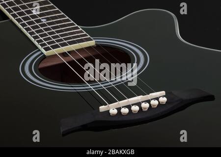 Body of black electric acoustic guitar on dark background Stock Photo