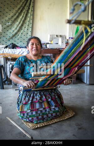 Lake Atitaln, Guatemala, 26th february 2020: mayan woman weaving colorful, traditional fabrics Stock Photo