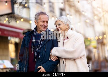 Elderly Couple Having Fun Outdoors At Christmas Time Stock Photo