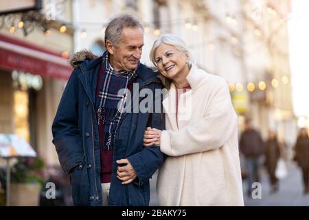 Elderly Couple Having Fun Outdoors At Christmas Time Stock Photo