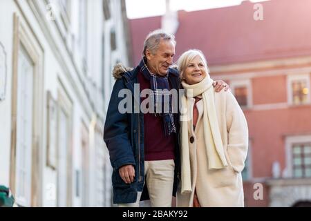 Senior couple walking on the city street at winter day Stock Photo