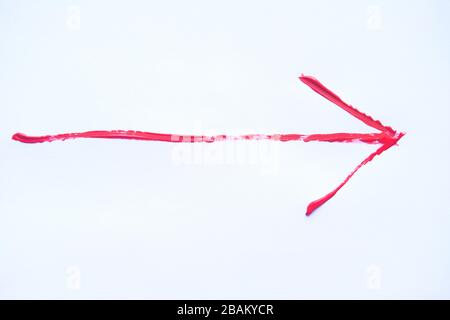 Red hand painted arrow with brush strokes isolated on the white background. Stock Photo