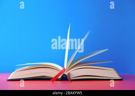 Opened empty book on blue background, space for text. Stock Photo