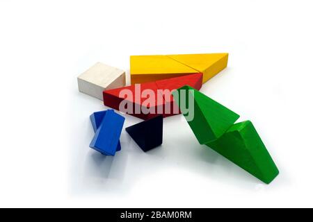 Tangram, Chinese traditional puzzle game made of different colorful wooden pieces that come together in a distinct shape, in a wooden box. Isolated on Stock Photo