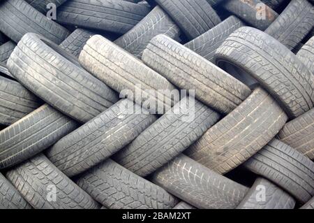 Used car tires, stacked on top of each other. Seasonal tire change. Stock Photo