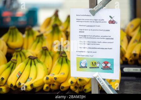 Coronavirus sign explaining rules on hygiene and social distancing on a fruit stall at an outdoor market in Veenendaal, the Netherlands Stock Photo