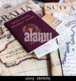 Milan, Italy – July 20, 2018 : An Italian passport and a smartphone over a tourist magazine. Preparations for a trip for South America or Australia. U Stock Photo