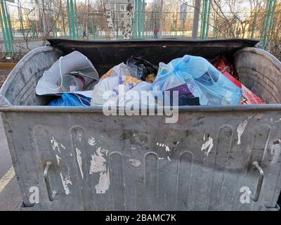 Overloaded dumpster, full garbage container, household garbage bin