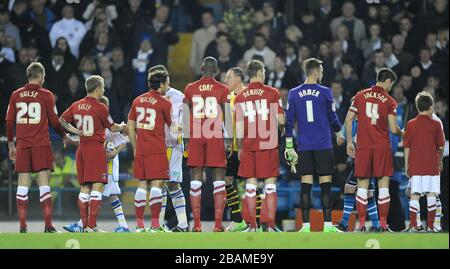 The two team's shake hands before kick-off Stock Photo