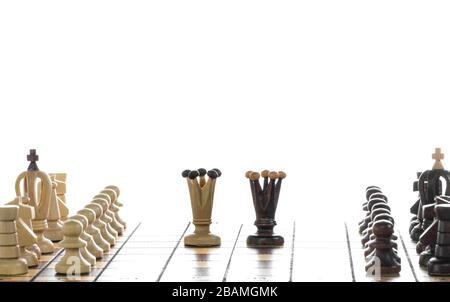 Wooden chess pieces on a chessboard. Black and white chess on chessboard, in white background. Stock Photo