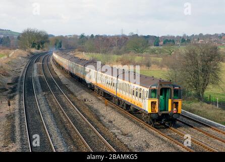 A class 47 diesel locomotive number 47840 working a train of former southern region electric multiple units that are due to be scrapped. Stock Photo