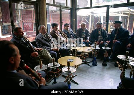 Group of men smoking hookah (nargile) at a cafe in Istanbul, Turkey Stock Photo