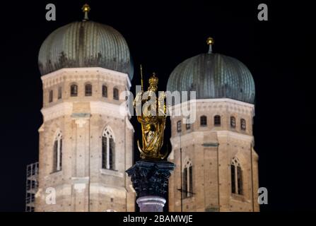 Munich, Germany. 28th Mar, 2020. The Frauenkirche and the Mariensäule recorded shortly before 'Earth Hour'. All over the world the lights go out for an hour on Saturday at many buildings and sights to set an example for climate and environmental protection. Credit: Sven Hoppe/dpa/Alamy Live News Stock Photo