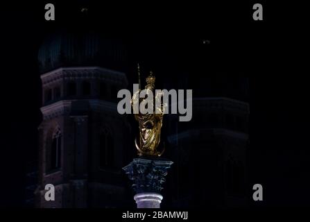 Munich, Germany. 28th Mar, 2020. The Frauenkirche and the Mariensäule photographed unlit during 'Earth Hour'. All over the world the lights go out for an hour on Saturday at many buildings and sights to set an example for climate and environmental protection. Credit: Sven Hoppe/dpa/Alamy Live News Stock Photo