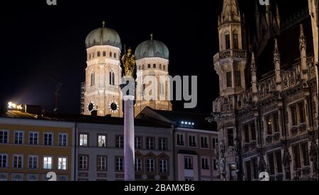 Munich, Germany. 28th Mar, 2020. The Frauenkirche, the Mariensäule and the Rathaus (r) recorded shortly before 'Earth Hour'. All over the world the lights go out for an hour on Saturday at many buildings and sights to set an example for climate and environmental protection. Credit: Sven Hoppe/dpa/Alamy Live News Stock Photo
