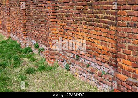 Old red brick fence from used broken brick Stock Photo