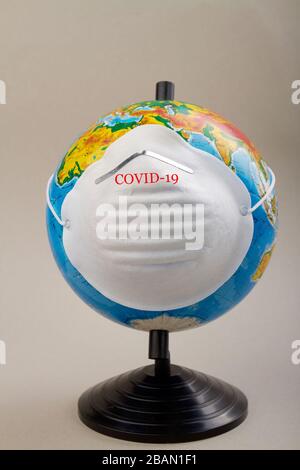 World globe wearing protective mask to protect from coronavirus. Stock Photo