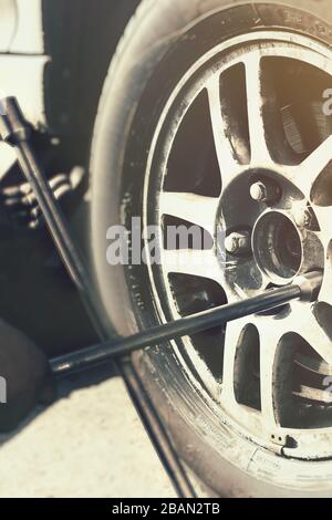 A car wheel with wheel wrench close up view Stock Photo