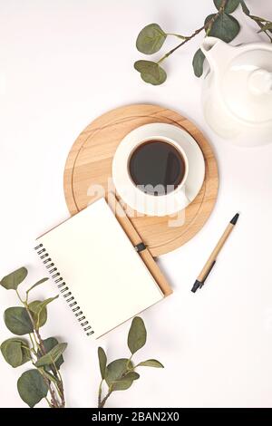 Cup coffee, pencil, branch with leaf, paper note on white background. Stock Photo