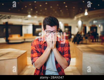people and work concept - tired man with eyeglasses in office Stock Photo