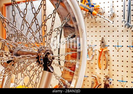 Custom wheel and tools in the bicycle workshop. Selective focus Stock Photo