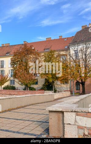 Budapest, Hungary - Nov 6, 2019: Beautiful street in the historical old town of Hungarian capital city photographed with autumn trees. Historical buildings, no people. Eastern European town. Stock Photo