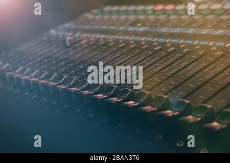 Professional audio and sound mixer control panel with buttons sliders and faders Stock Photo