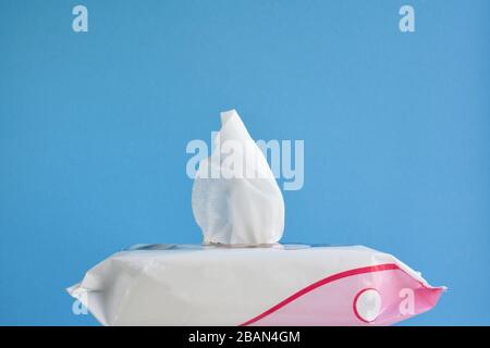 hand sanitizer on blue background, disposable wet wipes with an antiseptic to prevent coronavirus infection and personal hygiene Stock Photo