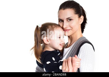 Mother and toddler girl child in baby carrier Stock Photo