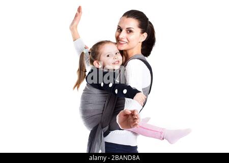 Mother and girl child in baby carrier having fun together Stock Photo