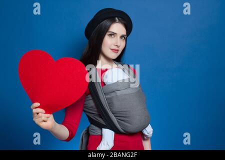 Young babywearing mother and baby in woven wrap Stock Photo