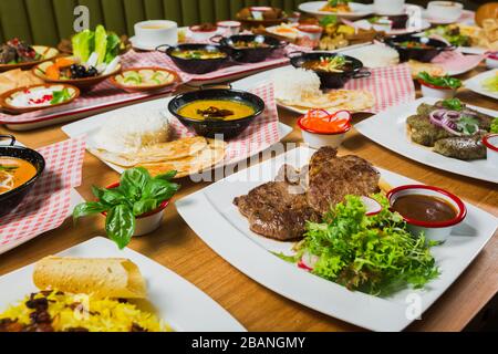 Red lentil Indian soup with flat bread on a wooden background. Masoor dal. Stock Photo