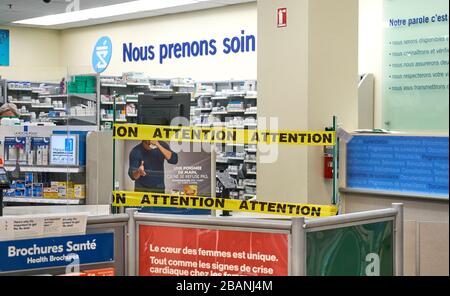 Montreal, Canada - March 28, 2020: Attention writing and tape at prescription section at Pharmacy. New procedure implemented in Quebec when people cop Stock Photo