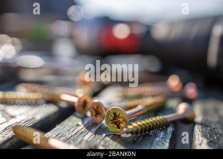 Tool and screw on a wooden plate with perspective blurs Stock Photo